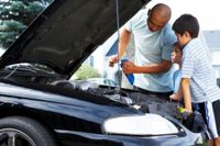 Father and sons checking the oil, to illustrate a spiritual multipoint inspection